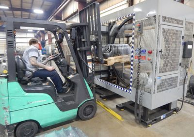 TAB Wrapper Tornado wrapping round flighting on pallet at Falcon Industries with green forklift